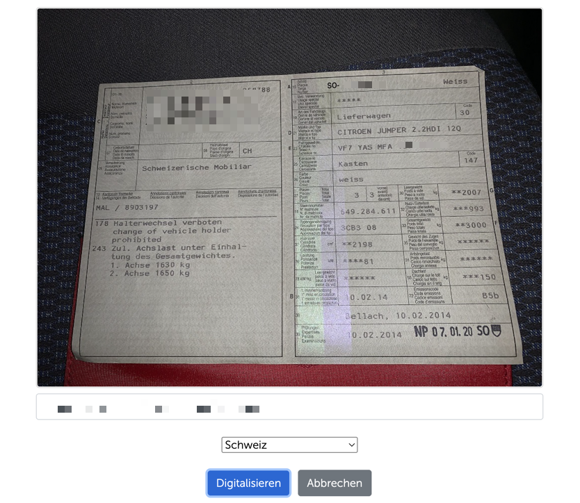 Aufgeklappter Schweizer Fahrzeugausweis im Scanner, persönliche Daten verpixelt